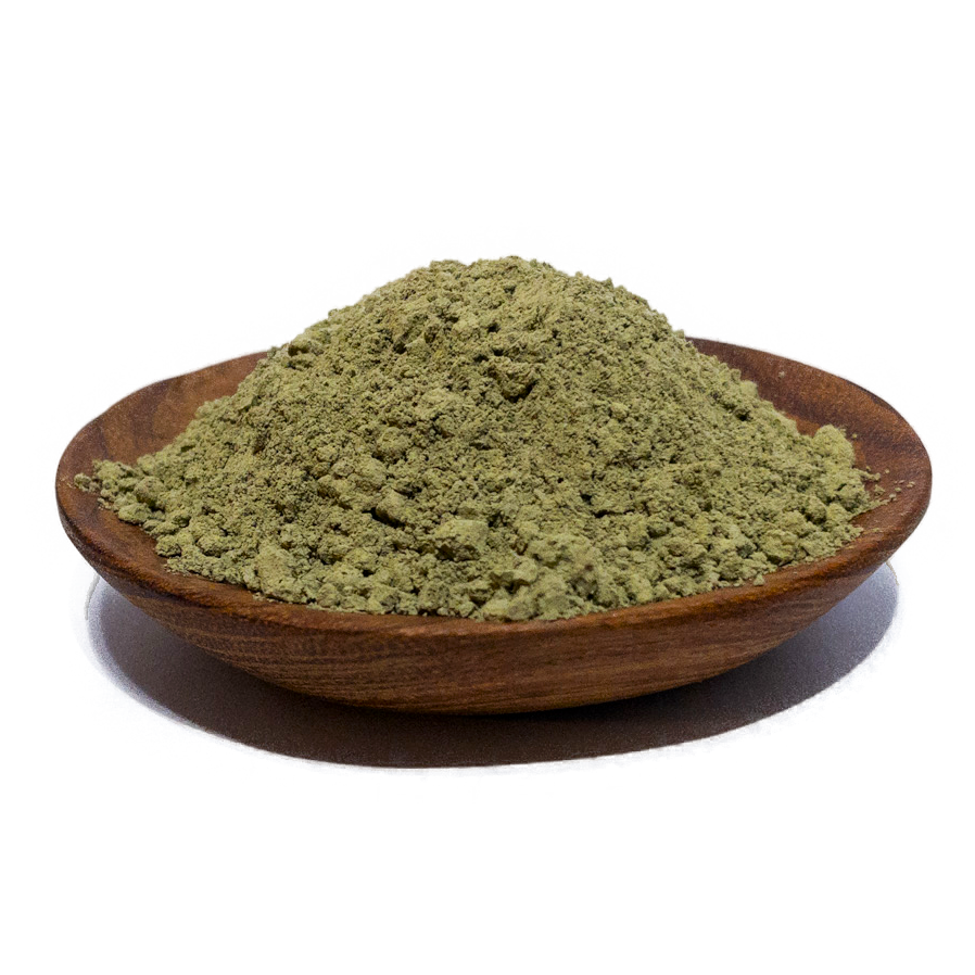 Green herbal powder in a wooden bowl, commonly used for natural remedies and supplements, highlighting its fine texture and vibrant color.
