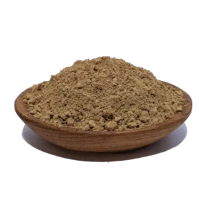 Mound of red herbal powder in a wooden bowl, showcasing its fine texture and earthy color