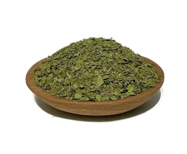 crushed Kratom leaves for tea mounted on a wooden bowl