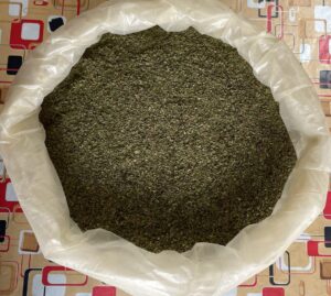 Large industrial bag full of crushed dry kratom leaves